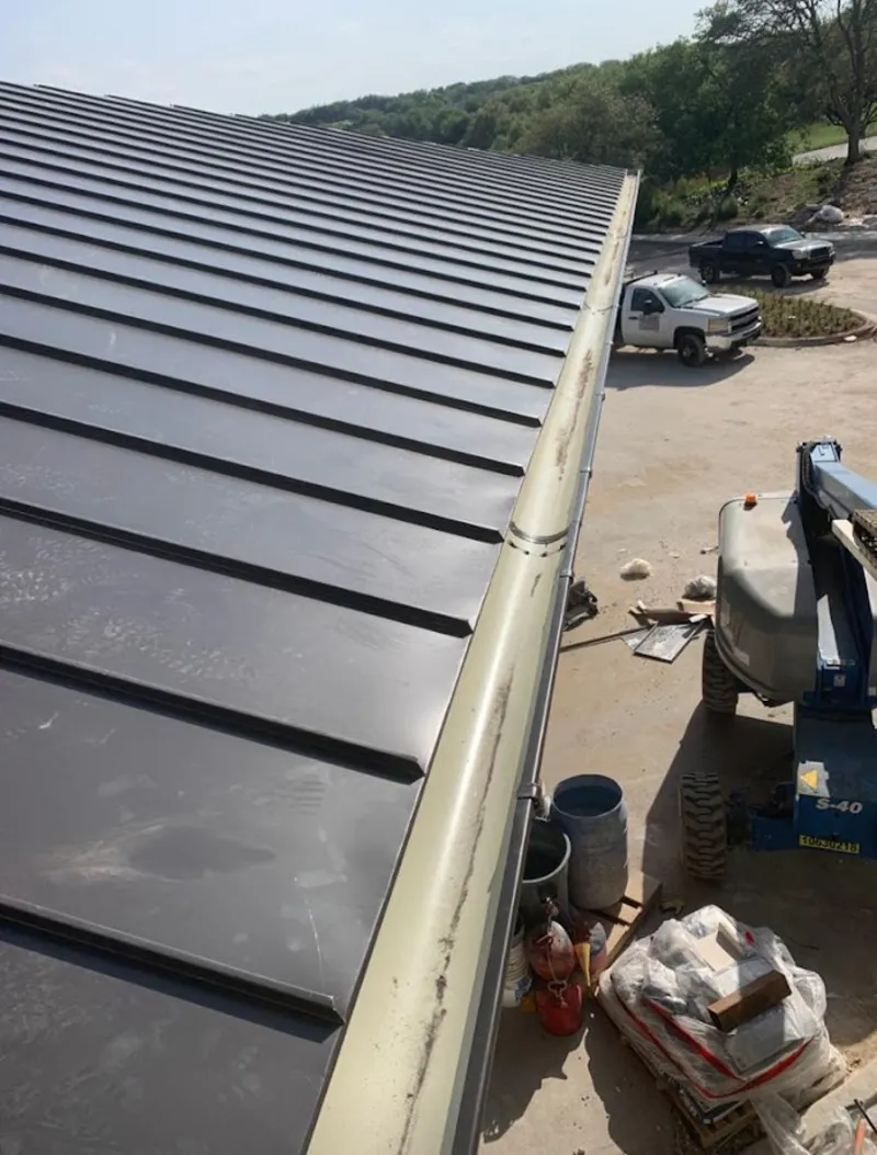 Standing seam panel and gutter detail on a metal roofing jobsite in Fussels Corner